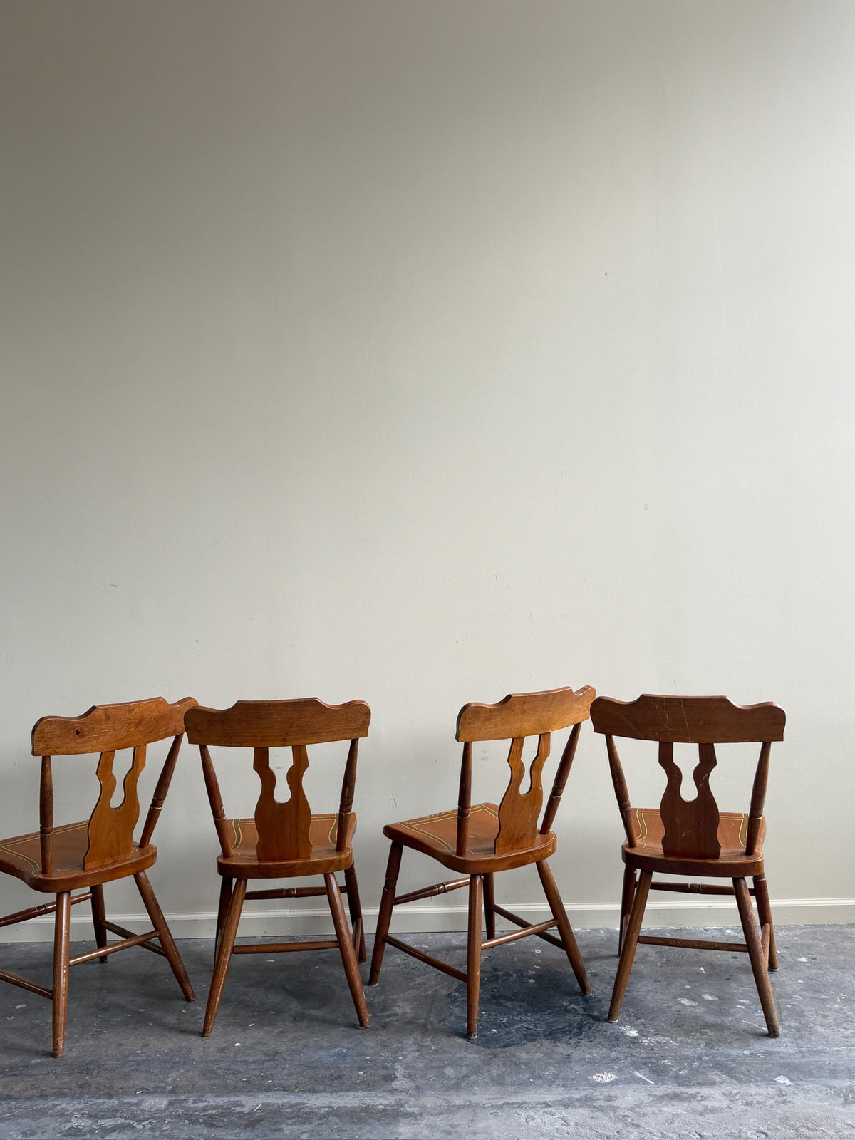 Pennsylvania painted pine plank seat dining chairs. Sold in pairs.