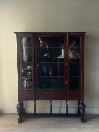 Glass display case with carved base