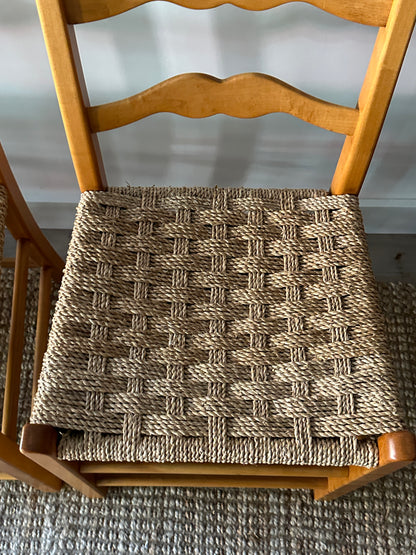 Ladder back chairs with woven seats. Sold in sets of 2.