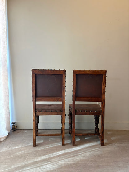 Leather and oak dining chairs with rips. Set of 2.