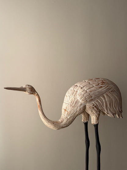 Wooden carved egret statue with iron legs