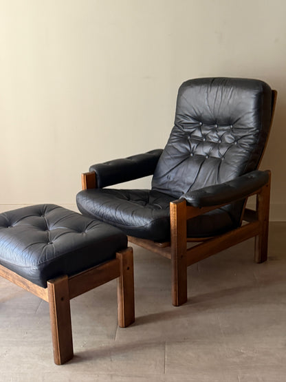 Reclining leather armchair with ottoman