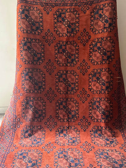 Low pile, rust colored rug