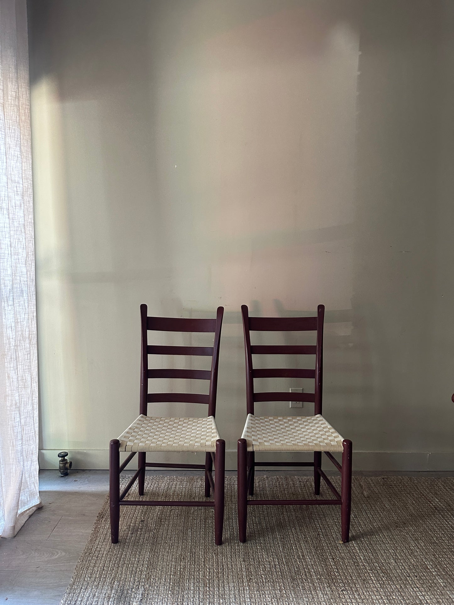Armless woven chairs. Sold as a pair.