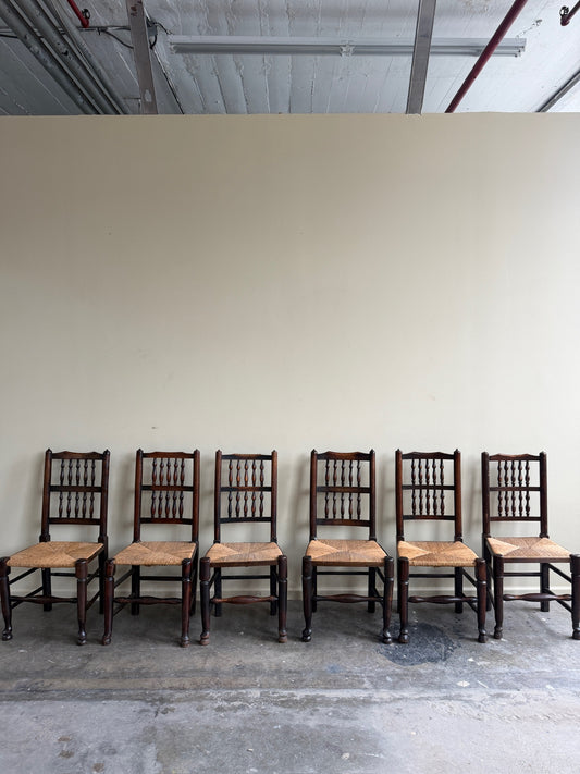 Dutch oak spindle back rush seat dining chairs. Sold in pairs.