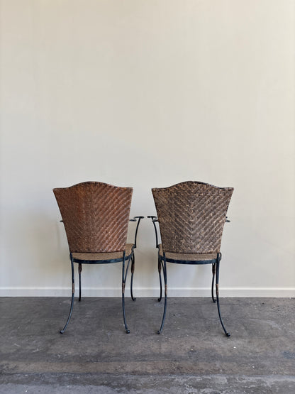 Wrought iron armchairs with woven bamboo backs & seats. Sold individually.