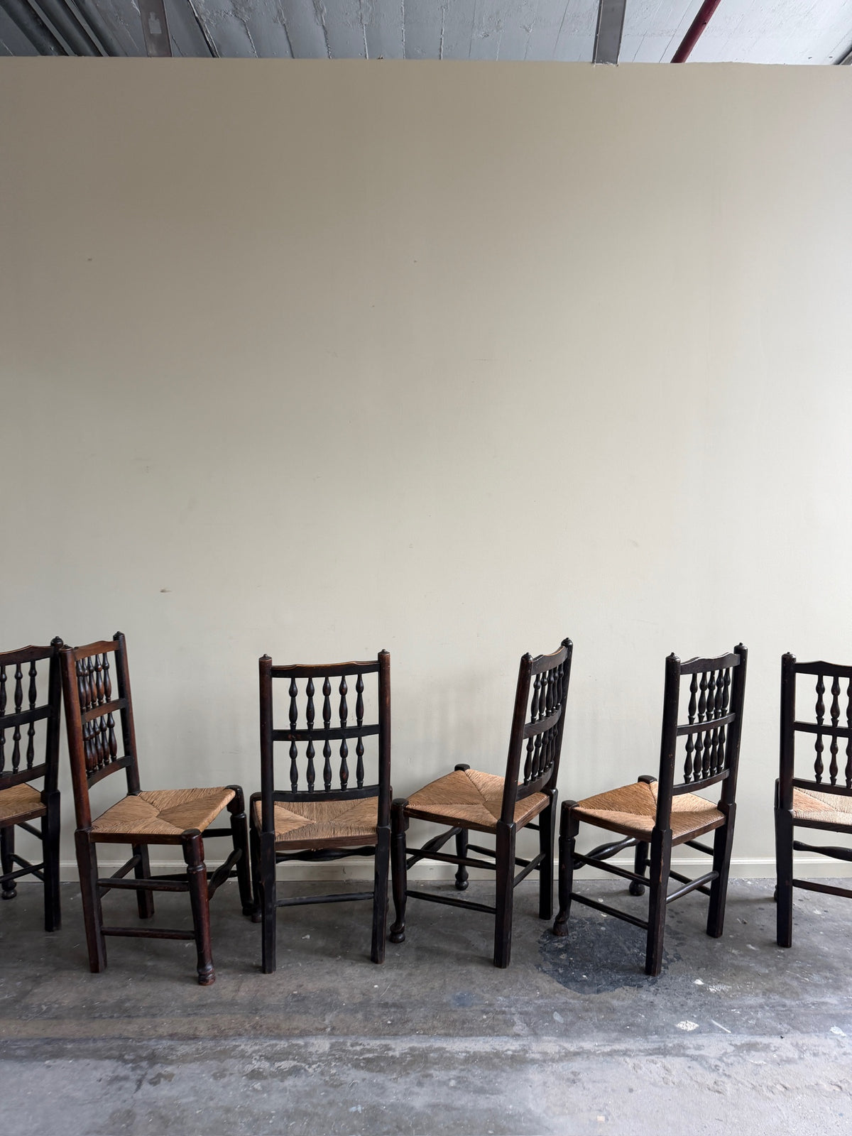 Dutch oak spindle back rush seat dining chairs. Sold in pairs.