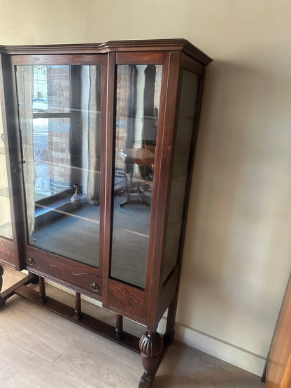 Glass display case with carved base