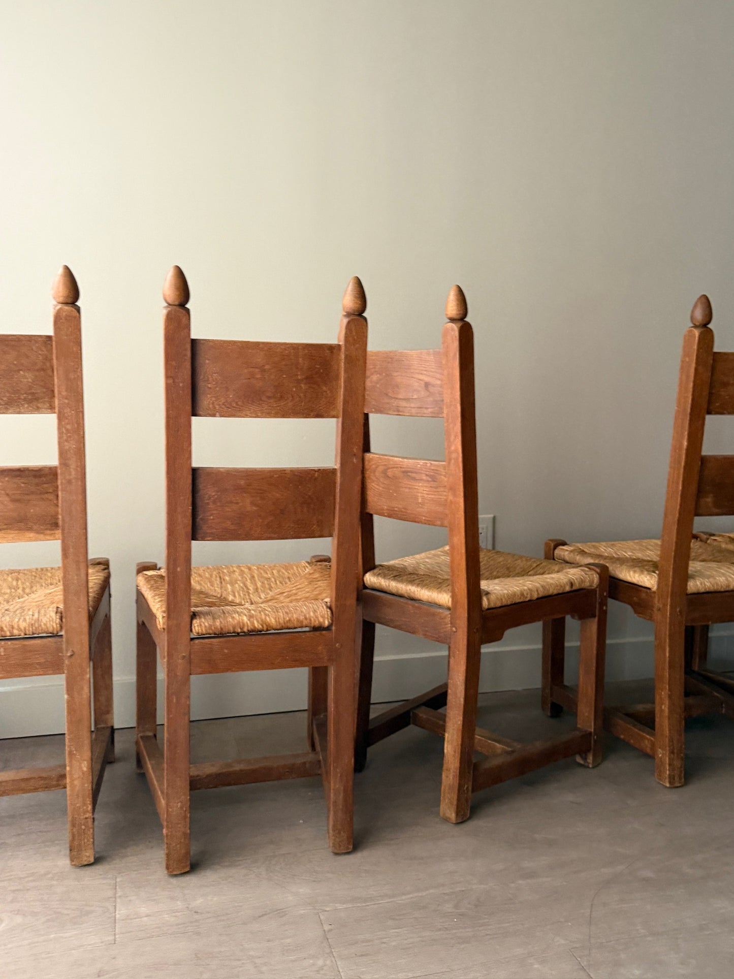 Dutch Brutalist oak rush seat dining chairs. Sold in pairs.