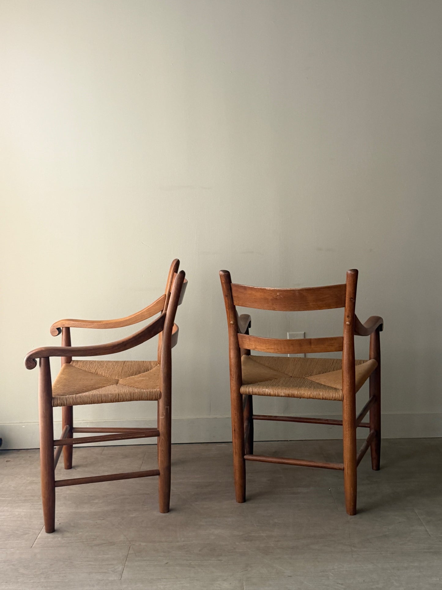 Pine rush seat dining chairs with arms. Sold as a pair.
