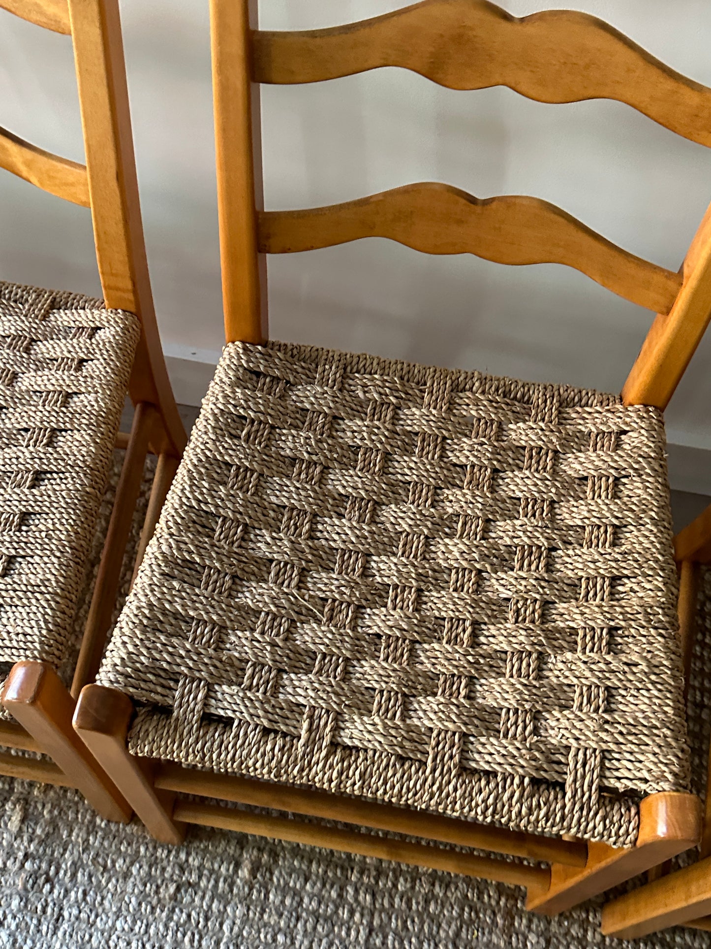 Ladder back chairs with woven seats. Sold in sets of 2.