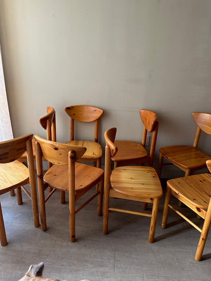 Rainer Daumiller pine cat-eye dining chairs. Sold in sets of 2.