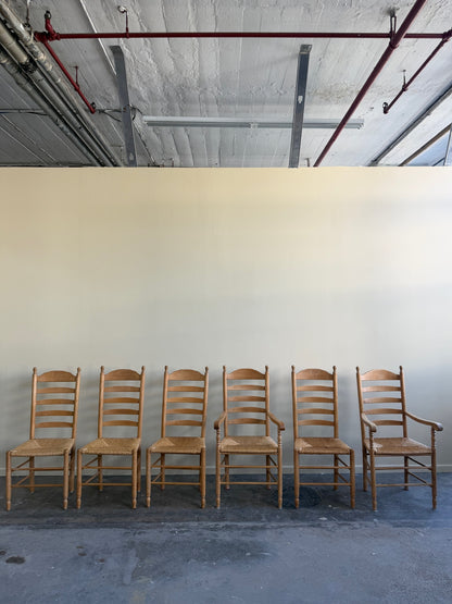 Beech ladder back rush seat arm chairs. Sold individually.