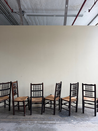 Dutch oak spindle back rush seat dining chairs. Sold in pairs.