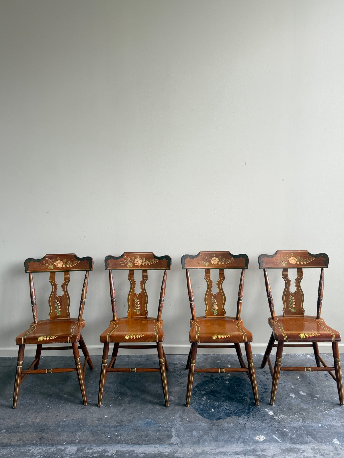 Pennsylvania painted pine plank seat dining chairs. Sold in pairs.