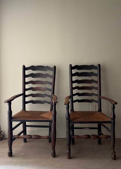 English provincial elmwood ladder back rush seat armchairs. Sold individually.