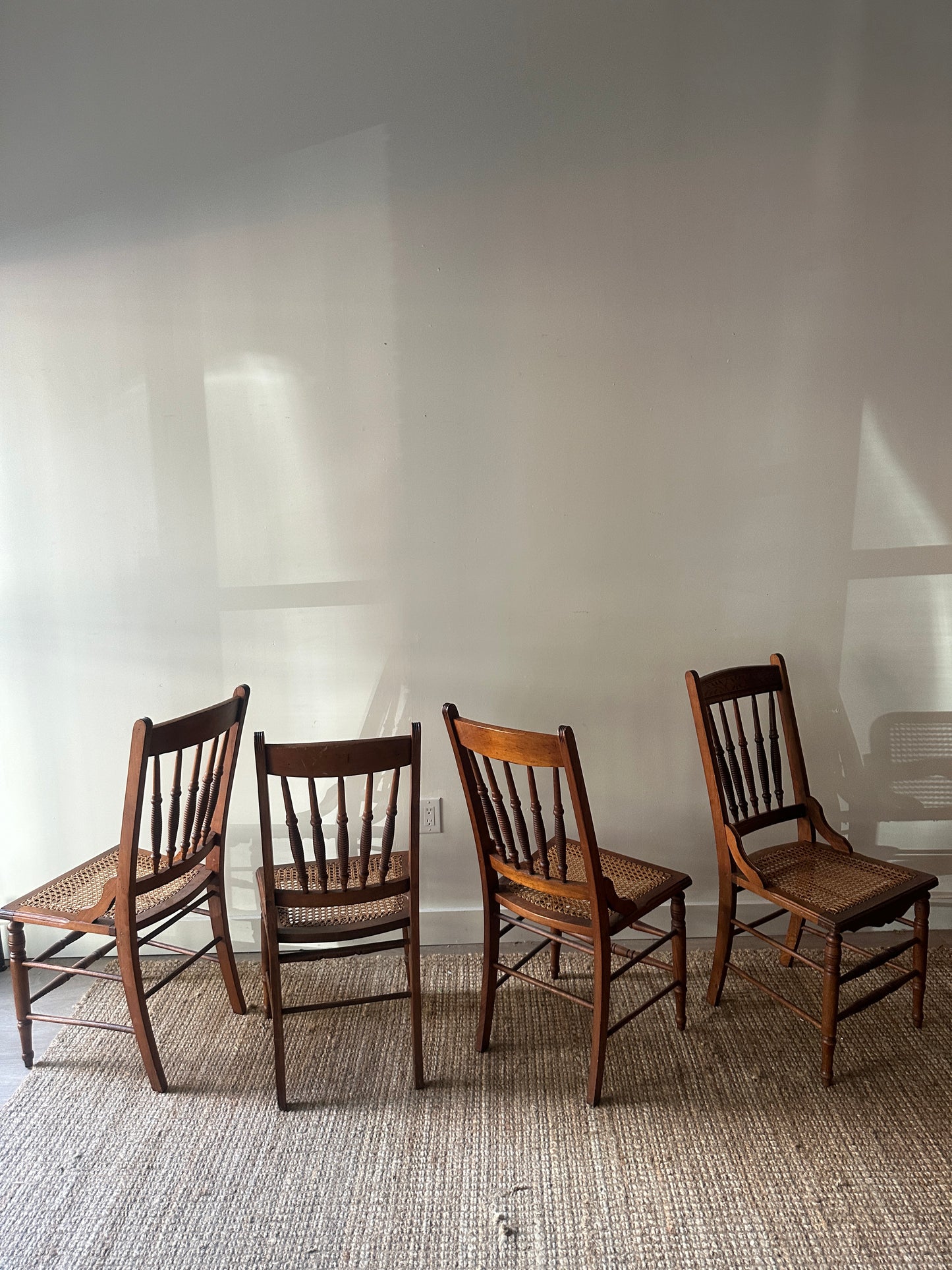 Carved cane chairs. Sold individually.