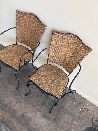 Wrought iron armchairs with woven bamboo backs & seats. Sold individually.