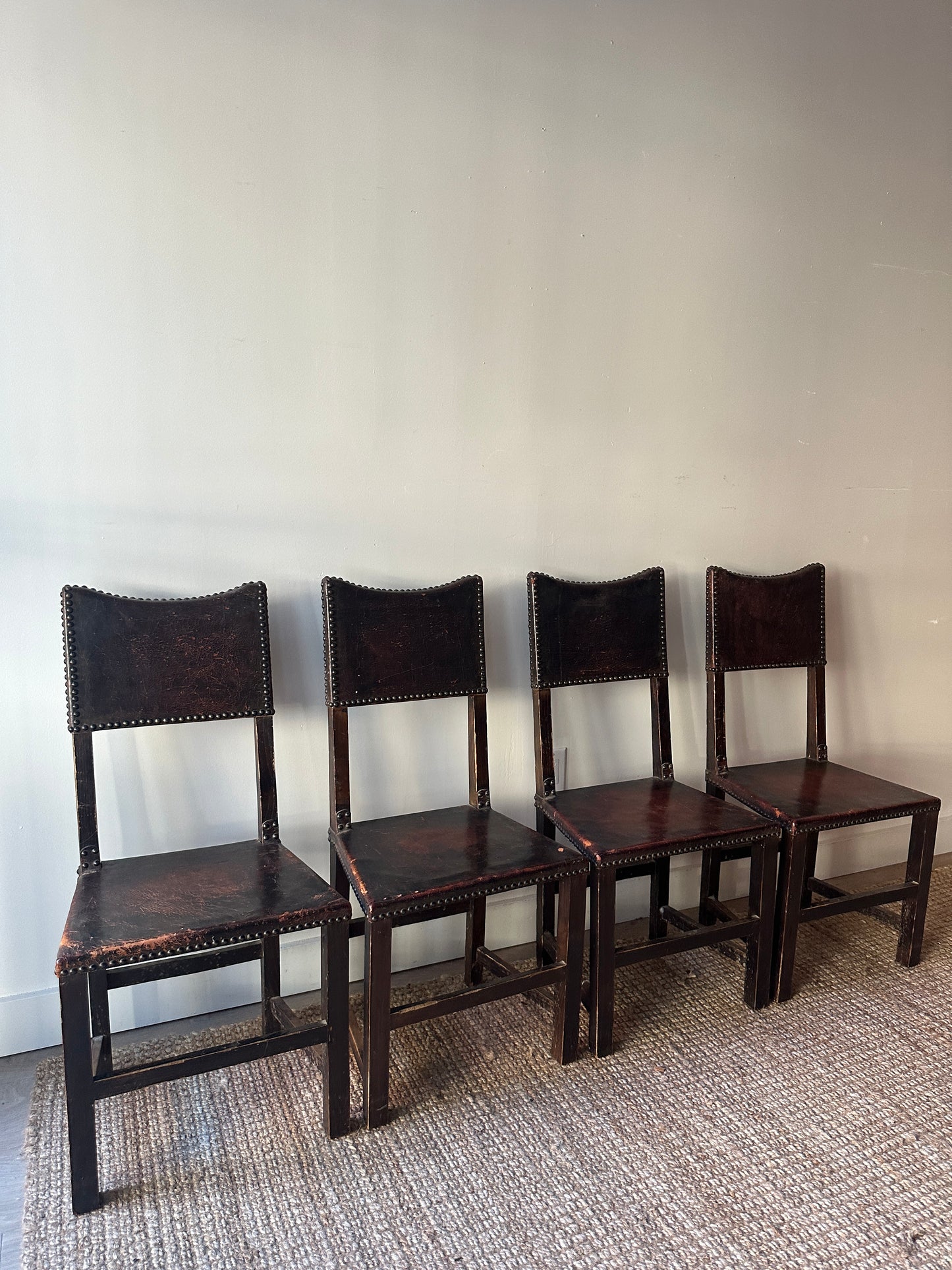 Leather and walnut nailhead dining chairs. Sold individually.