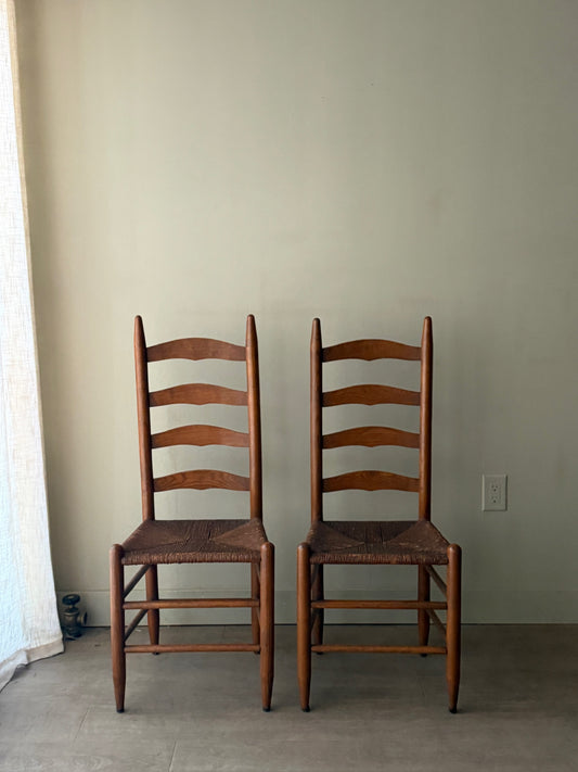 Oak ladder back rush seat dining chairs. Sold as a pair.