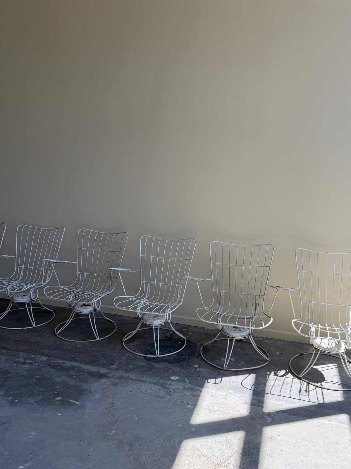 White swivel patio chairs. Sold individually.