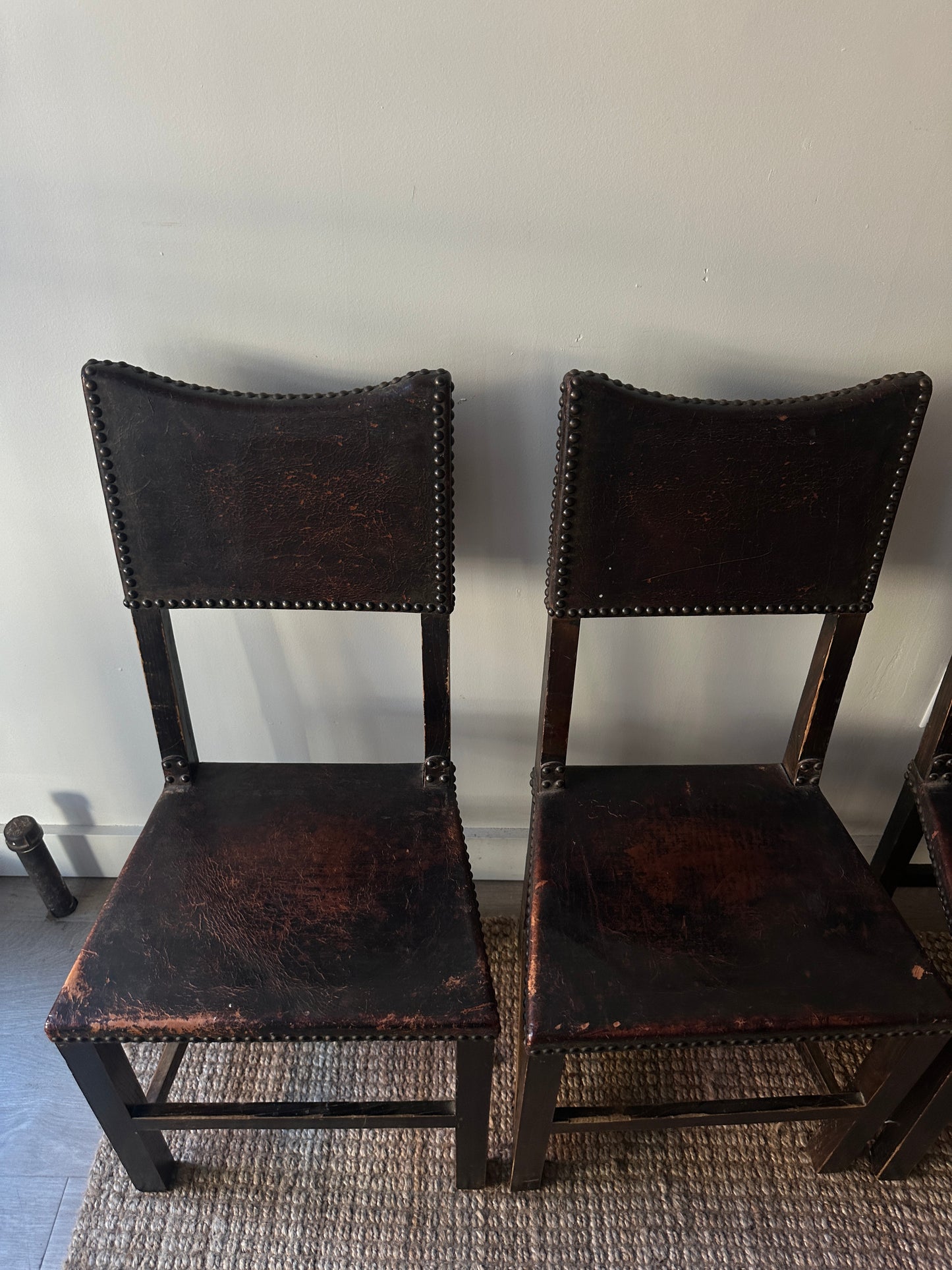 Leather and walnut nailhead dining chairs. Sold individually.