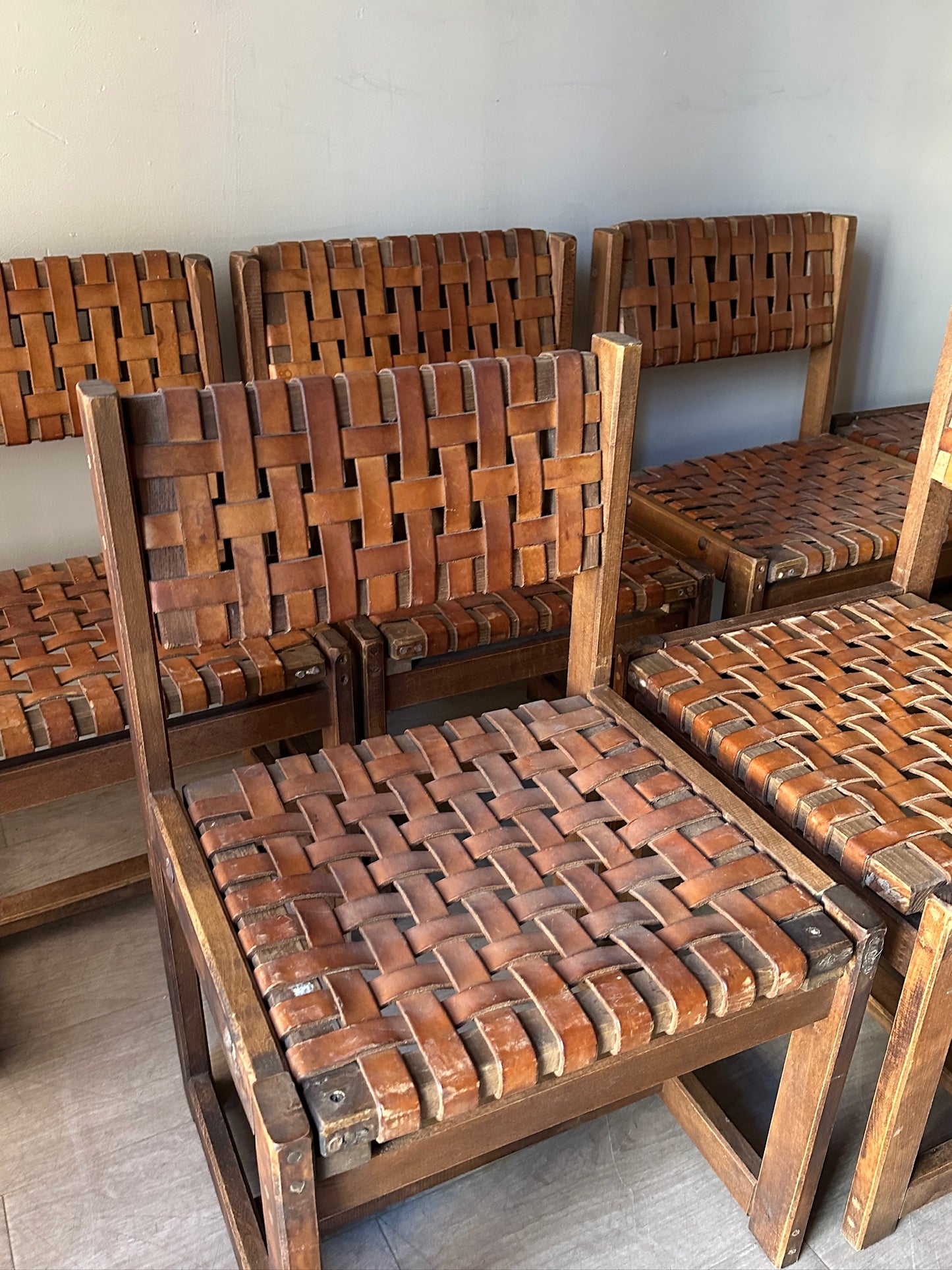 10 Jens Risom style woven leather dining chairs. Sold individually.