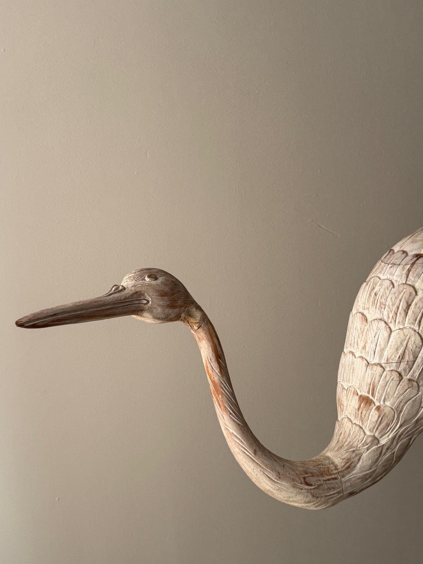 Wooden carved egret statue with iron legs