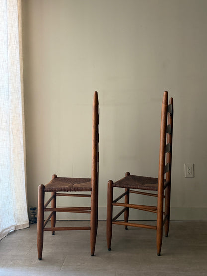 Oak ladder back rush seat dining chairs. Sold as a pair.