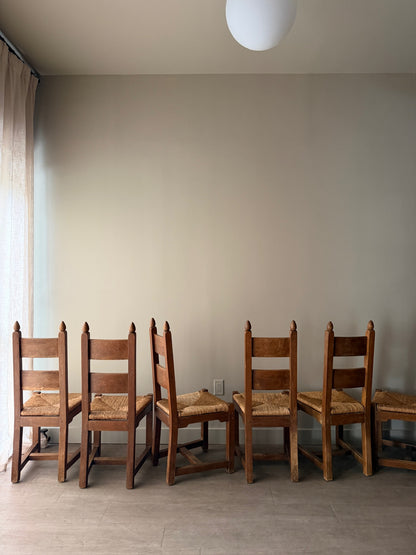 Dutch Brutalist oak rush seat dining chairs. Sold in pairs.