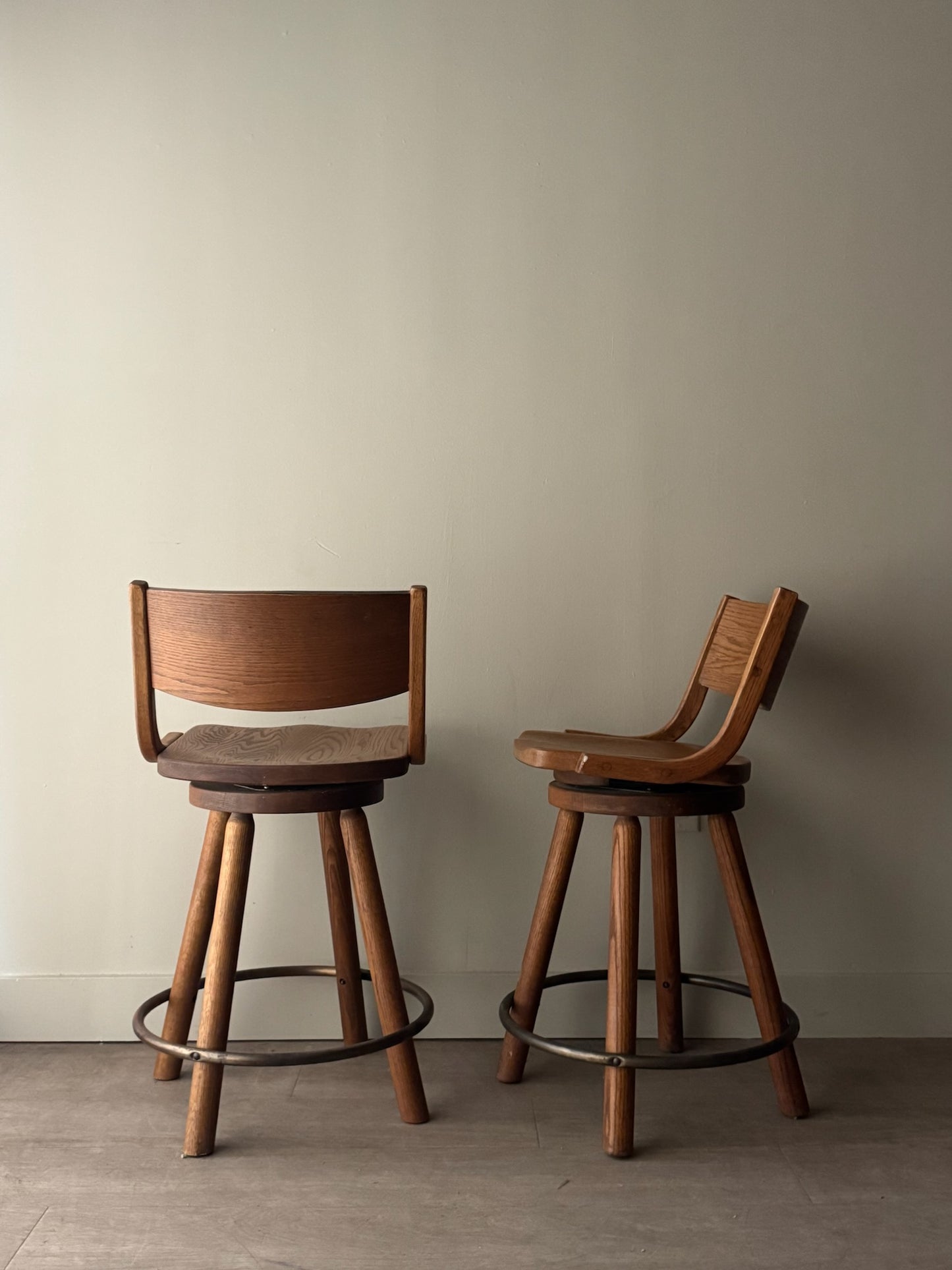 Conant Ball oak swivel bar stools. Sold as a pair.
