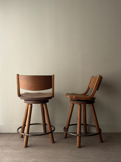Conant Ball oak swivel bar stools. Sold as a pair.