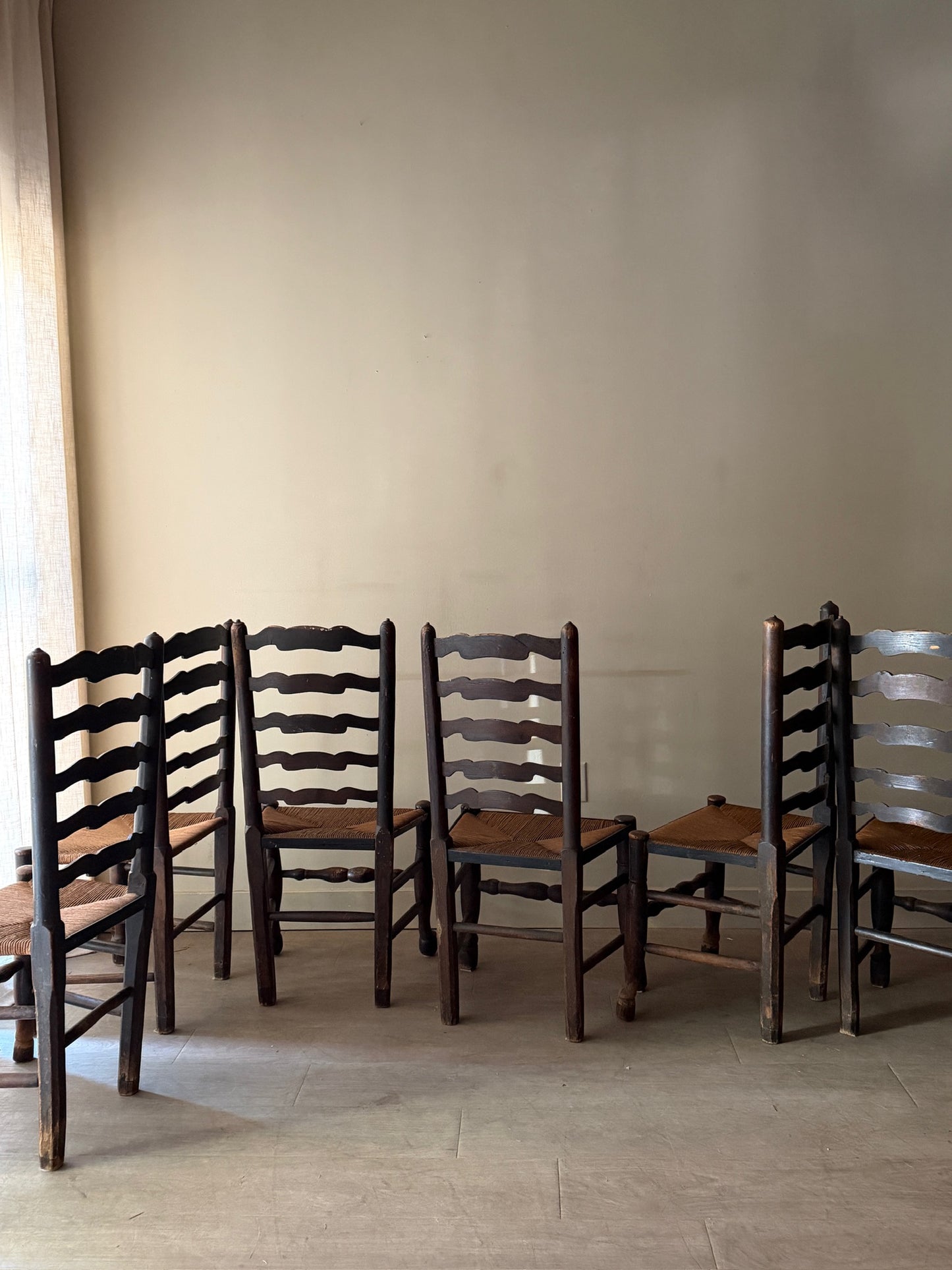 English provincial elmwood ladder back rush seat chairs. Sold in pairs.