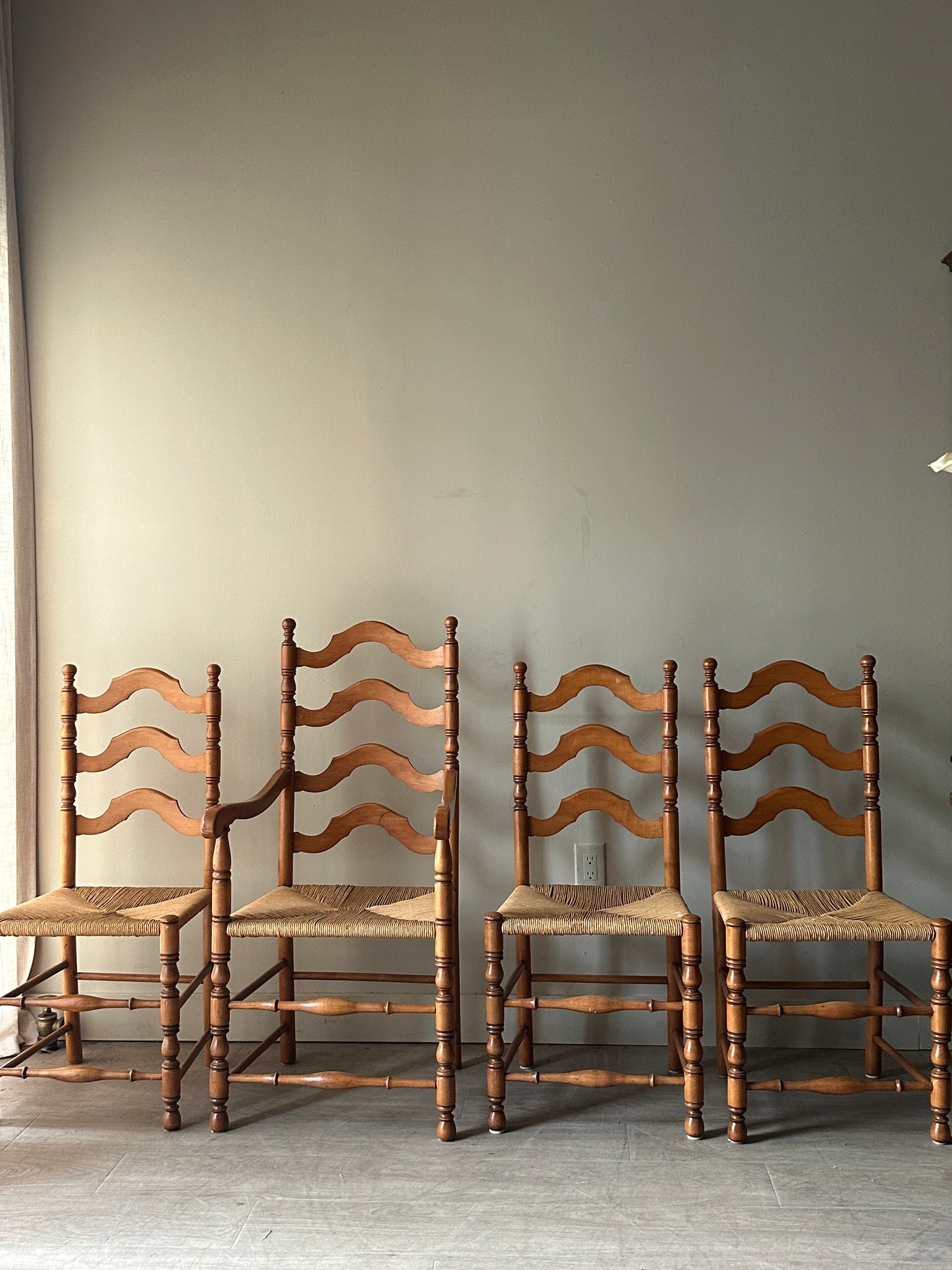 Set of 4 maple and rush dining chairs. 3 armless, 1 arm. Sold as set