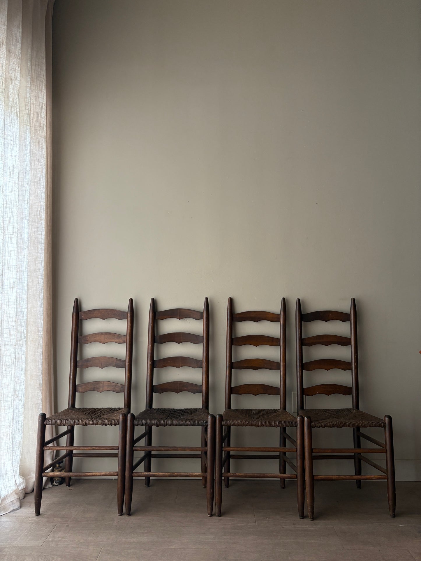 Stained oak rush seat ladder back dining chairs. Sold in pairs.