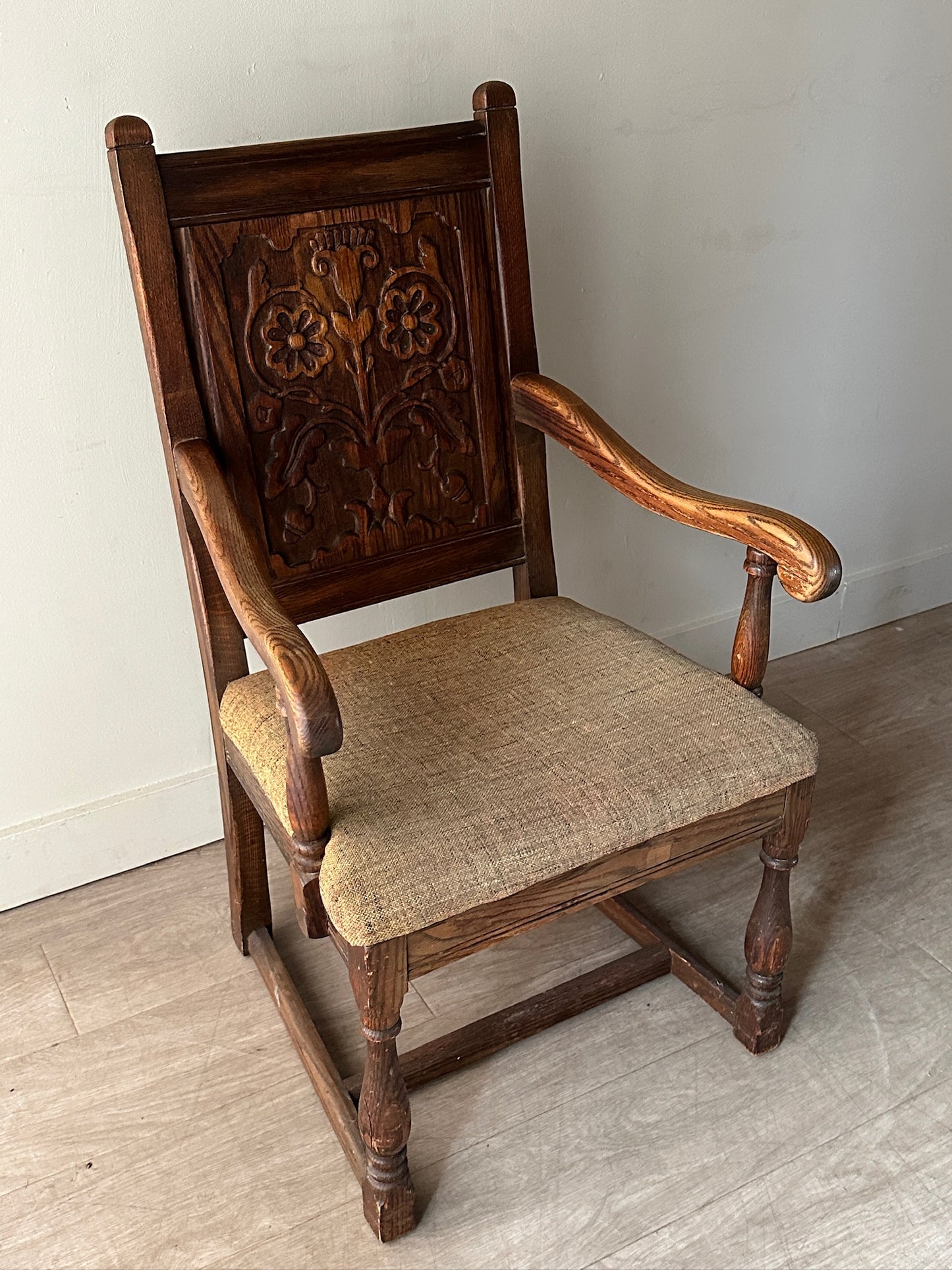 Carved oak upholstered armchair