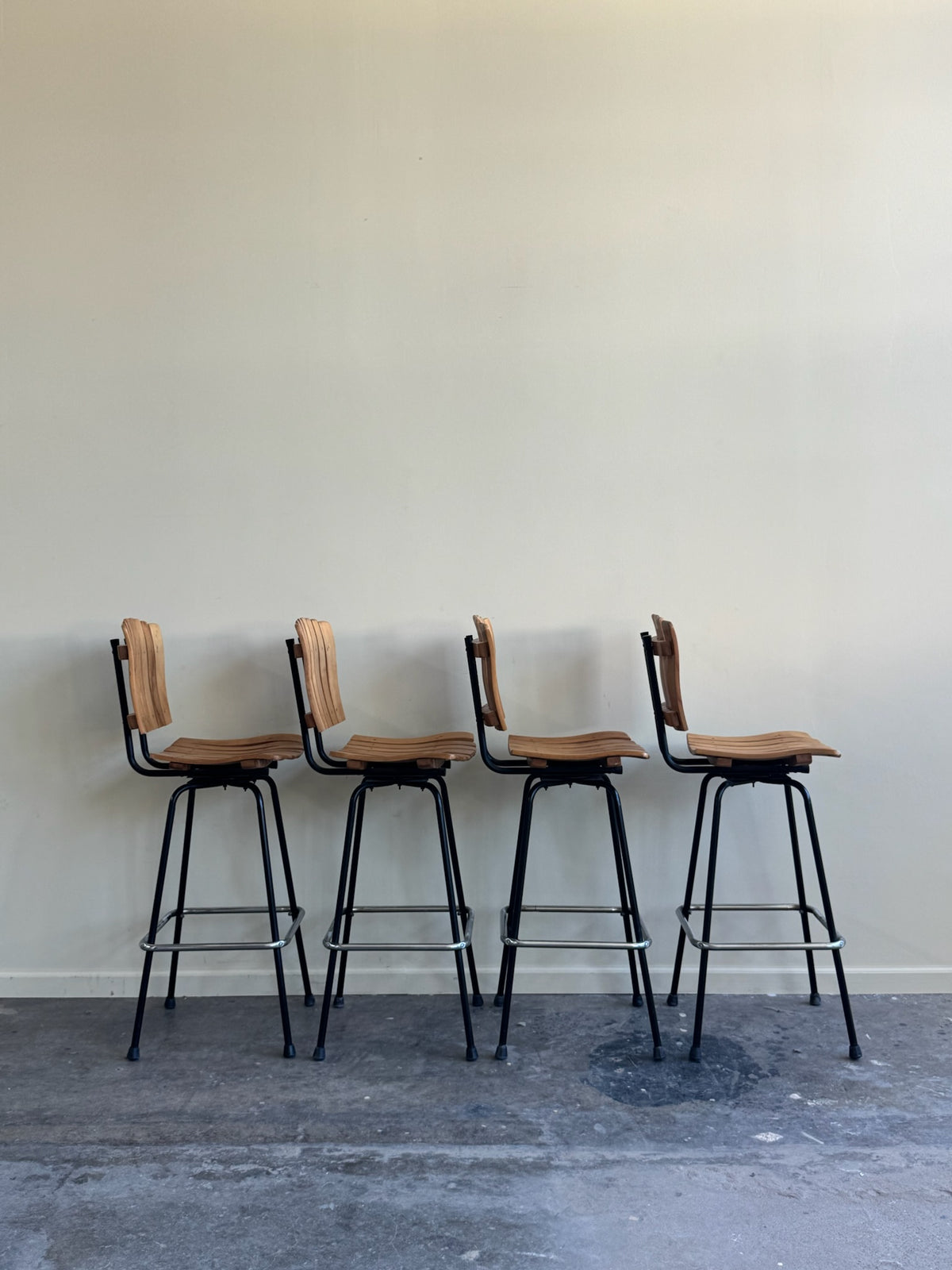 Slatted maple swivel bar stools. Sold in pairs.