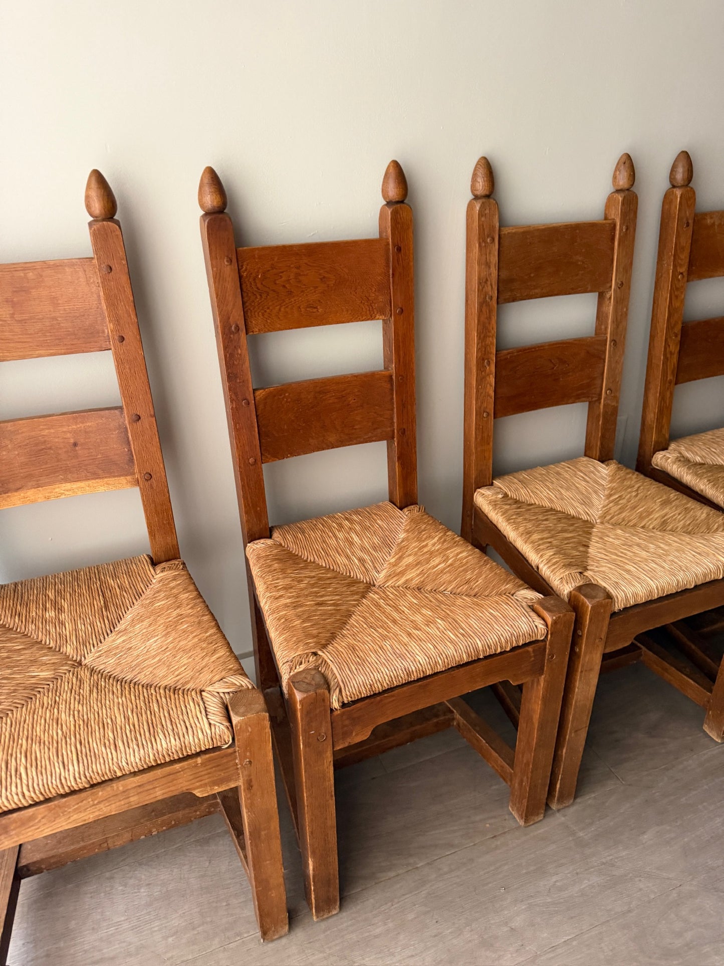 Dutch Brutalist oak rush seat dining chairs. Sold in pairs.