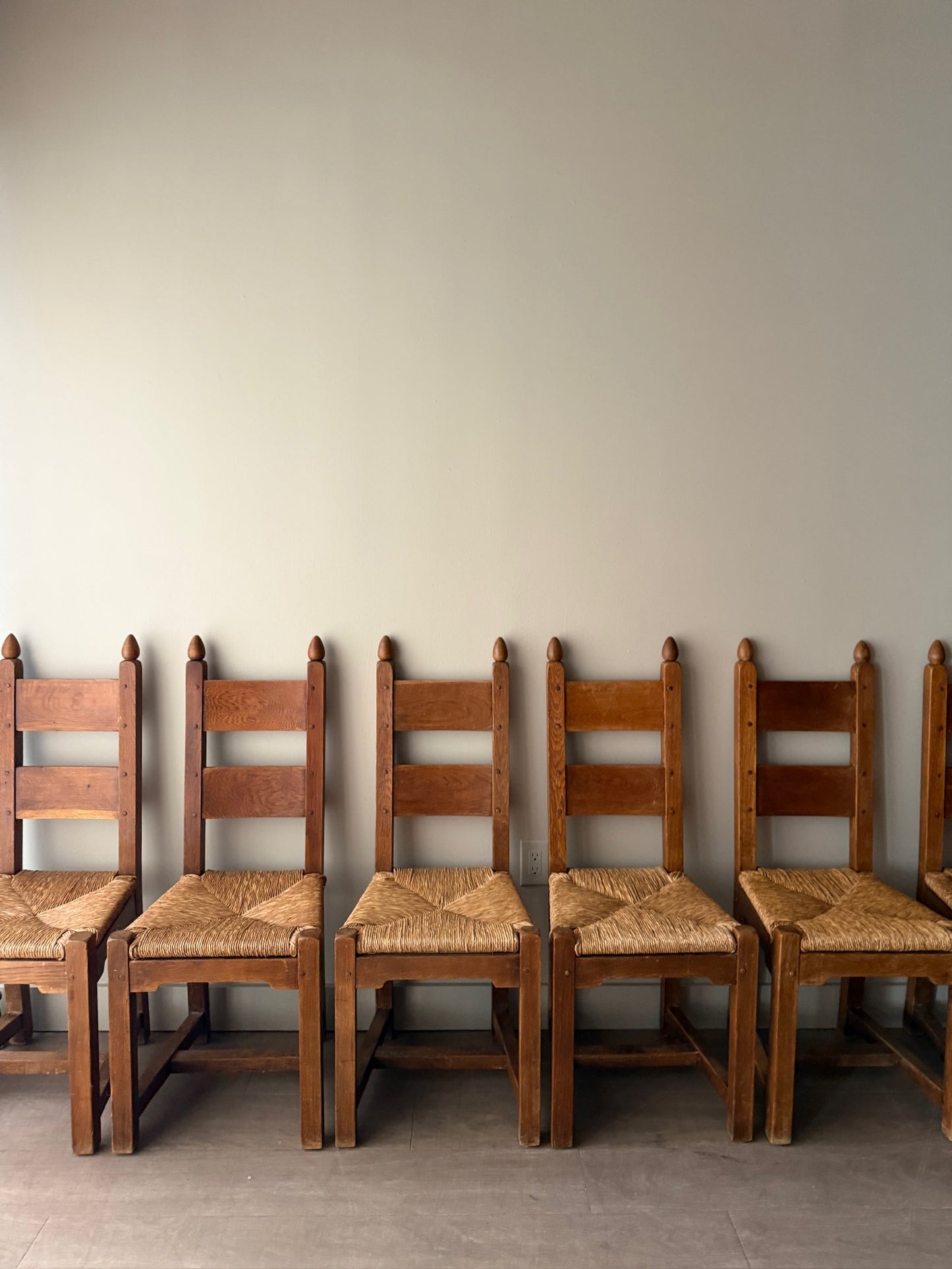Dutch Brutalist oak rush seat dining chairs. Sold in pairs.