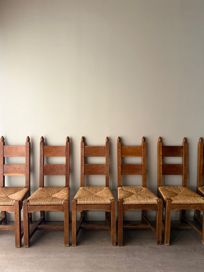 Dutch Brutalist oak rush seat dining chairs. Sold in pairs.