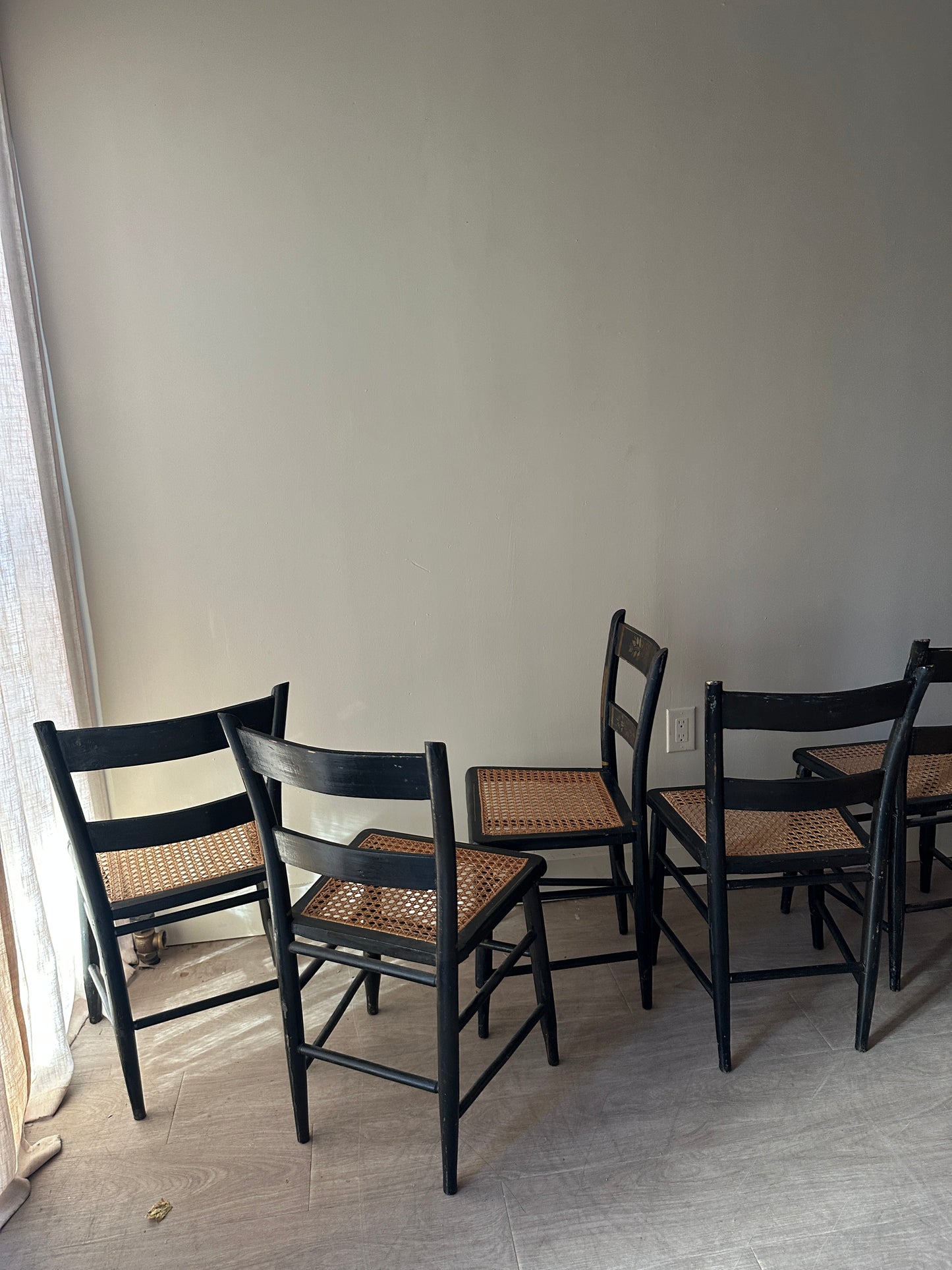 6 cane and black painted dining chairs. Sets of 2.