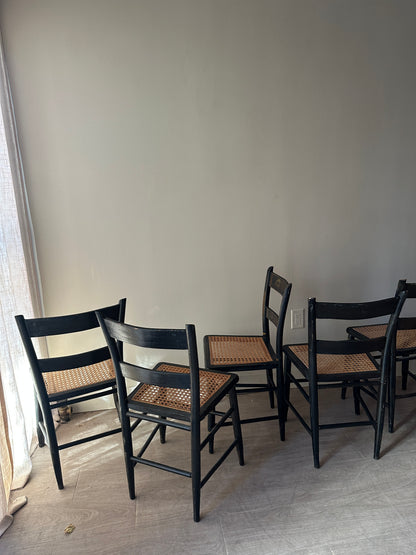 6 cane and black painted dining chairs. Sets of 2.