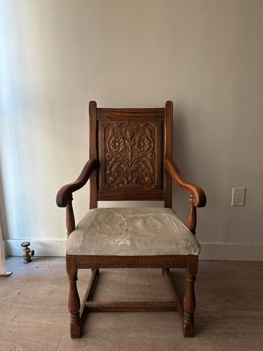 Carved oak and leather armchair