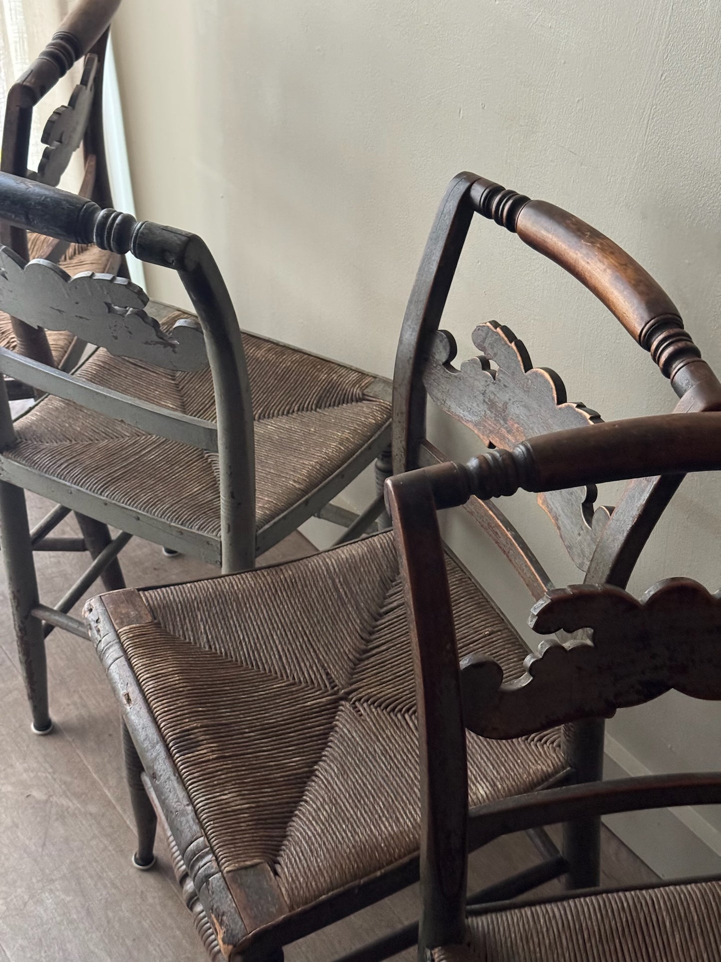 Carved dining chairs with rush seats. Sold in pairs.