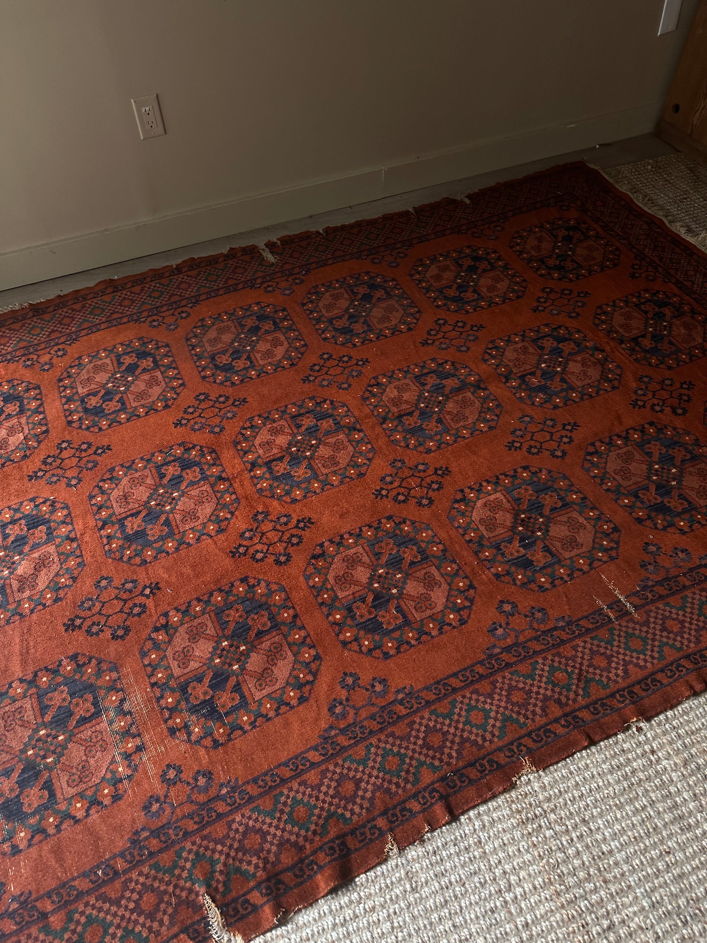 Low pile, rust colored rug