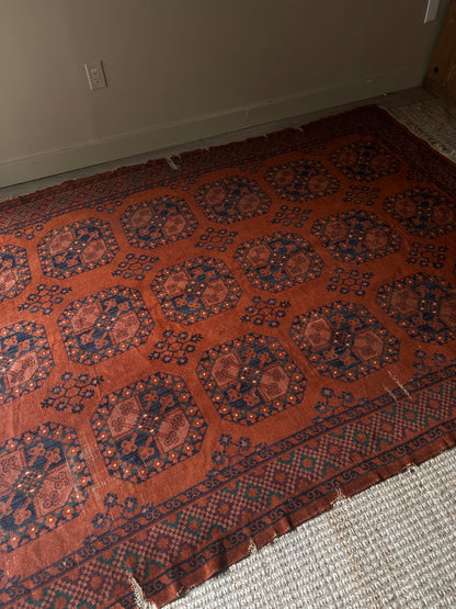 Low pile, rust colored rug