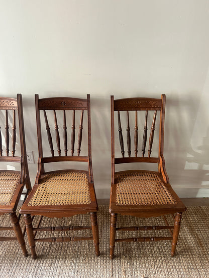 Carved cane chairs. Sold individually.