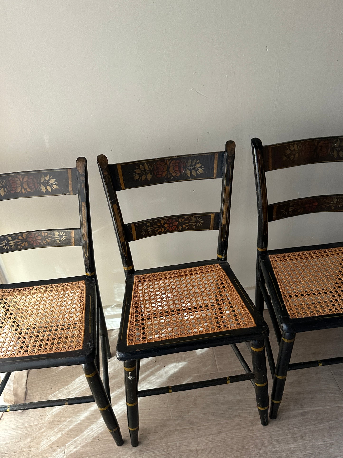 6 cane and black painted dining chairs. Sets of 2.
