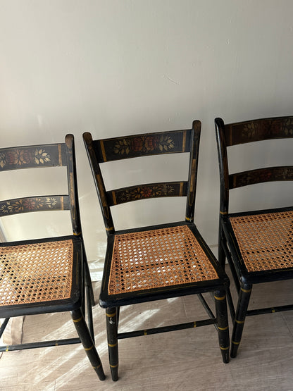 6 cane and black painted dining chairs. Sets of 2.