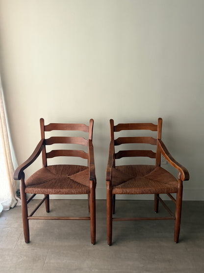 Ladder back rush seat pine arm chairs. Sold individually.